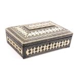 An Anglo Indian Sadeli work sewing box of sarcophogal form, circa 1830, in ivory, bone and steel,