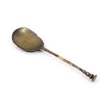 A 17th Century brass or laten seal top spoon, the fig shaped bowl stamped with a rose in circle,