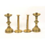Two pairs of brass candlesticks, comprising a Gothic style pair, 22cm, and a plain pair on domed