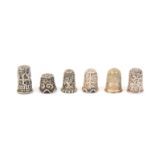 Five good Indian silver Kutch thimbles, and a Perakanese silver thimble, four of the Kutch