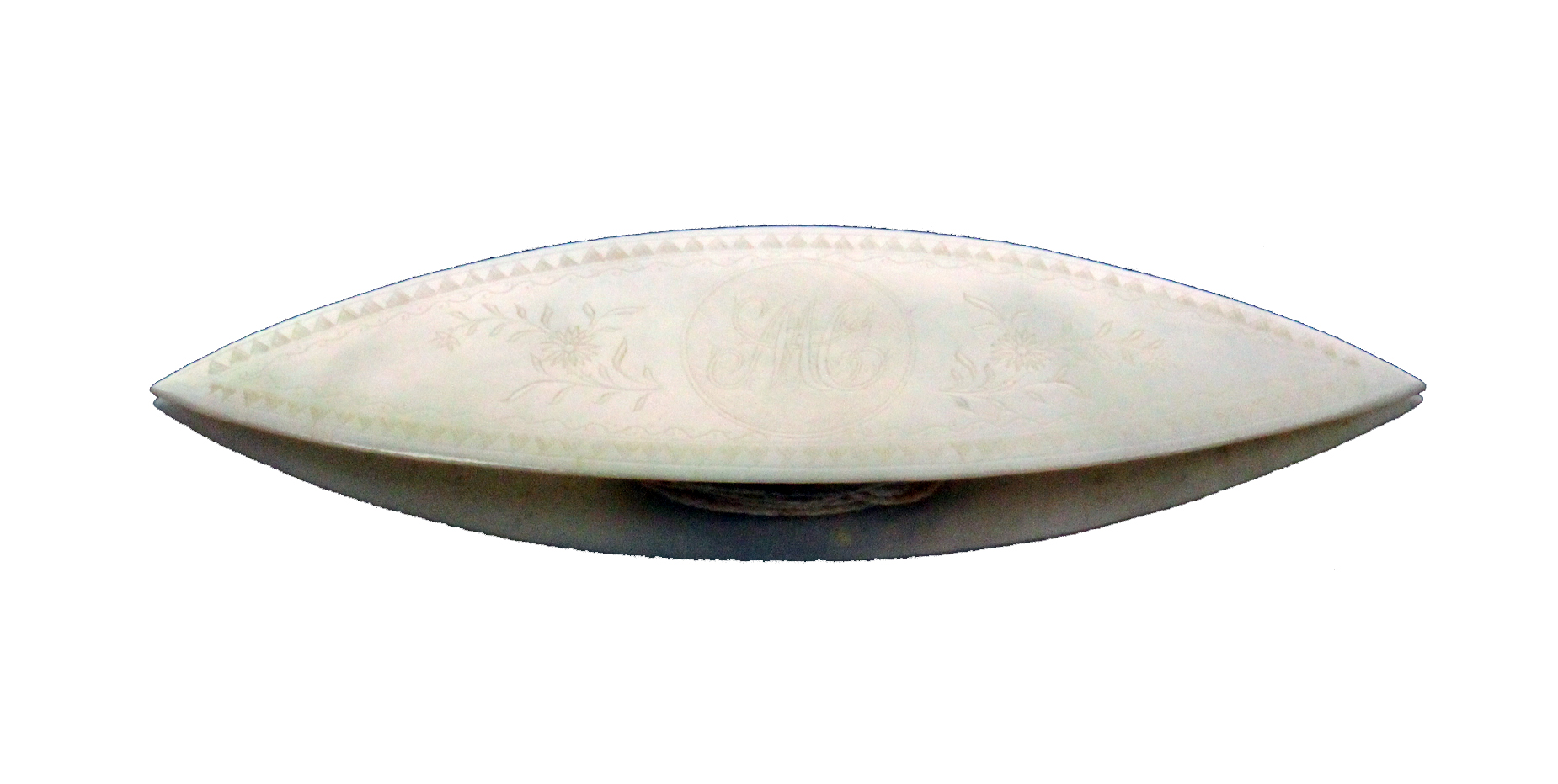 A Chinese mother of pearl engraved shuttle initialled 'MC' within flower sprays within a scroll