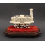 A 19th century carved and pierced ivory model of an early steam locomotive fitted as an ink stand,