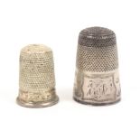 Two thimbles, comprising an elegant silver steel top example, the floral engraved frieze with a