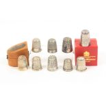 Various thimbles comprising seven hallmarked silver examples, one in Mauchline slant top box (