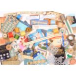 A mixed lot - sewing - comprising wooden reels, six knitting needle gauges, needle packets, button