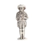A continental figural silver needle case, in the form of a male in breaches, decorated jacket and