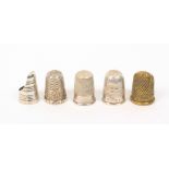 Five thimbles, comprising a silver thumb nail example marked 'Pat 19157', another in brass, a