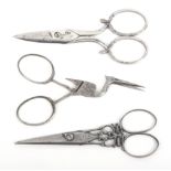 Three pairs of 19th century steel scissors comprising a pair with diamond section blades with finely