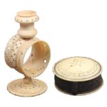 Two ivory pin cushions both with burnt circle decoration, the first of pedestal form to a girdle