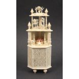 A fine 19th century carved and pierced ivory miniature model of a standing corner cupboard with