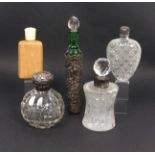 Five larger format scent bottles comprising a globular cut glass example with hinged silver cover,