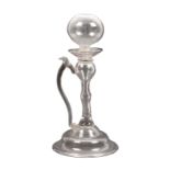A 19th century clear glass lace makers lamp the ball top on a hollow stem with curved handle, the