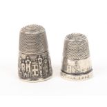 Two 19th Century pictorial silver thimbles, comprising Abbotsford, loss to rim, and 'International