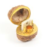 A good miniature etui in the form of a natural walnut, internal floral decorated tool mount with a