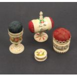 Three pin cushions and a waxer all in bone comprising a pedestal barrel form example painted with