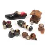 Seven wooden thimble cases and stands, comprising a Swiss chalet, 6.5cm, two pedestal acorns, a