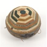 A late 18th Century pin ball, in shades of green, light brown and cream in bands of variant
