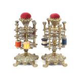 A pair of Victorian brass reel stands, each on a leaf cast base on four paw feet, the baluster