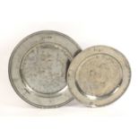 Two large pewter chargers, the largest with reeded rim with four touch marks struck twice, 46cm, and