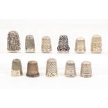 Seven English silver thimbles and four others, the seven all hallmarked, a heavy gauge white metal