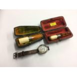 Two Cheroot holders and a wristwatch