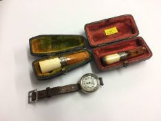 Two Cheroot holders and a wristwatch