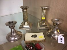 Two pairs of silver candlesticks