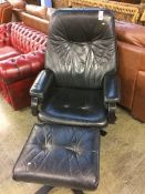 Danish black leather swivel chair and footstool by Unico