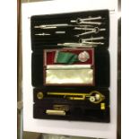 A cased planimeter, drawing set etc.