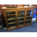 An oak glazed triple door bookcase