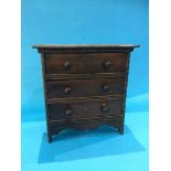 A miniature oak chest of drawers