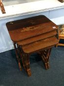 A quartetto of red lacquered tables