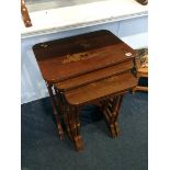 A quartetto of red lacquered tables