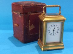 A small brass cased travelling carriage clock, together with fitted leather case