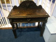 A carved oak side table with single drawer, 88cm wide