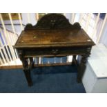 A carved oak side table with single drawer, 88cm wide