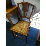 A pair of Edwardian cane seated chairs