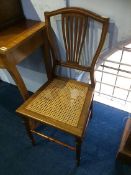 A pair of Edwardian cane seated chairs