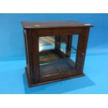 A small oak table top display cabinet
