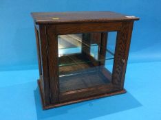 A small oak table top display cabinet