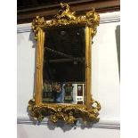 An ornate gilt mirror, 61 x 37cm