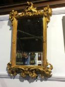 An ornate gilt mirror, 61 x 37cm