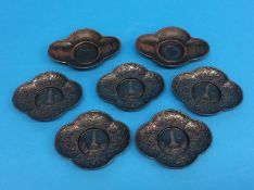 Two Japanese Imperial army metal sake saucers and a set of five saucers each depicting the Russo-