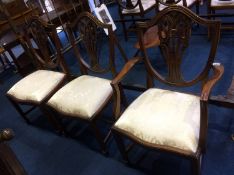 A set of six reproduction mahogany Chapmans 'Siesta' dining chairs, comprising four single and two