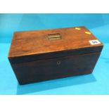 A mahogany tea caddy with fitted interior