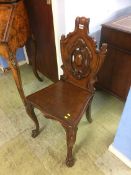 A Victorian mahogany carved hall chair