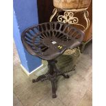 A tractor seat style stool and a plant stand