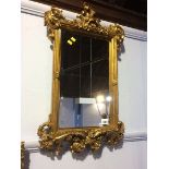 An ornate gilt mirror, 61 x 37cm
