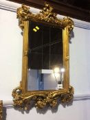 An ornate gilt mirror, 61 x 37cm