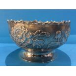 An Oriental white metal bowl decorated with chrysanthemums, marks to base , 18.7oz